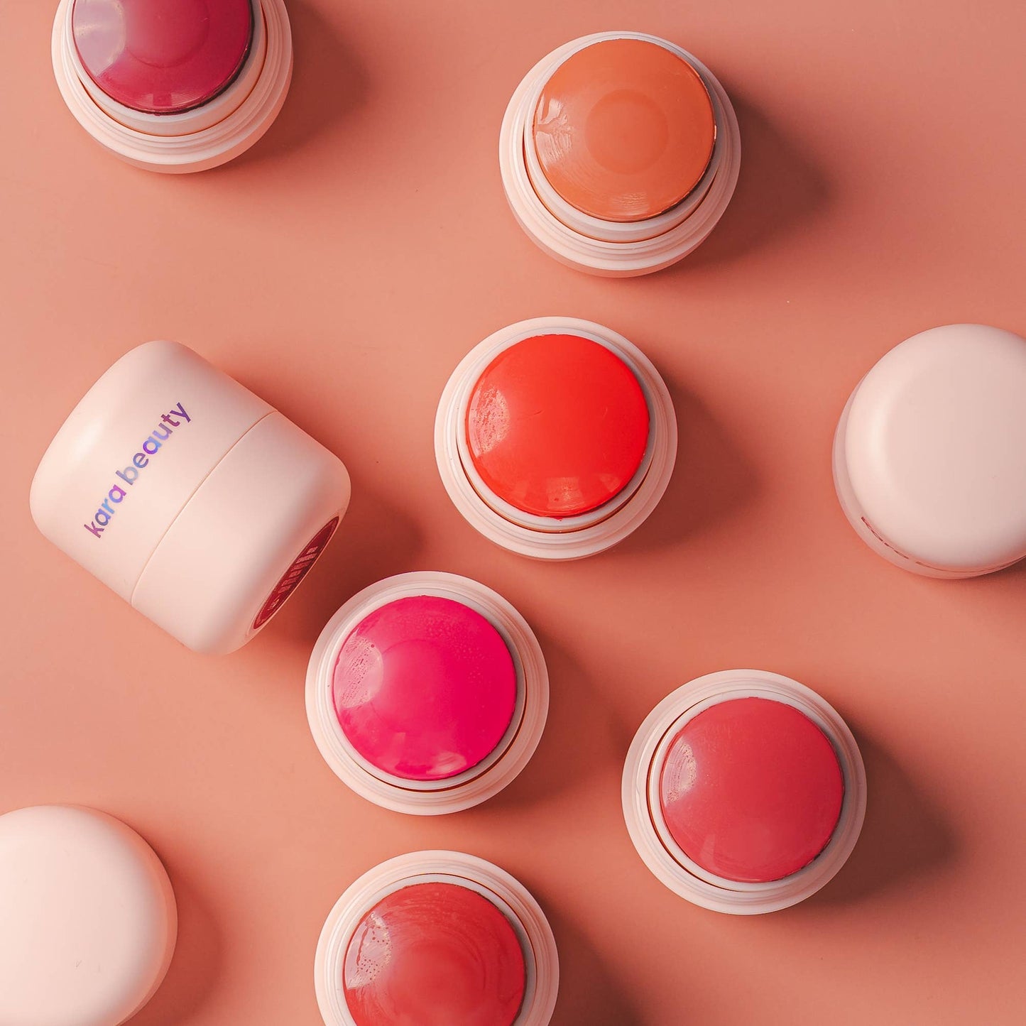 Set of blush cheek balm pots with red and pink balm shades and clear lids