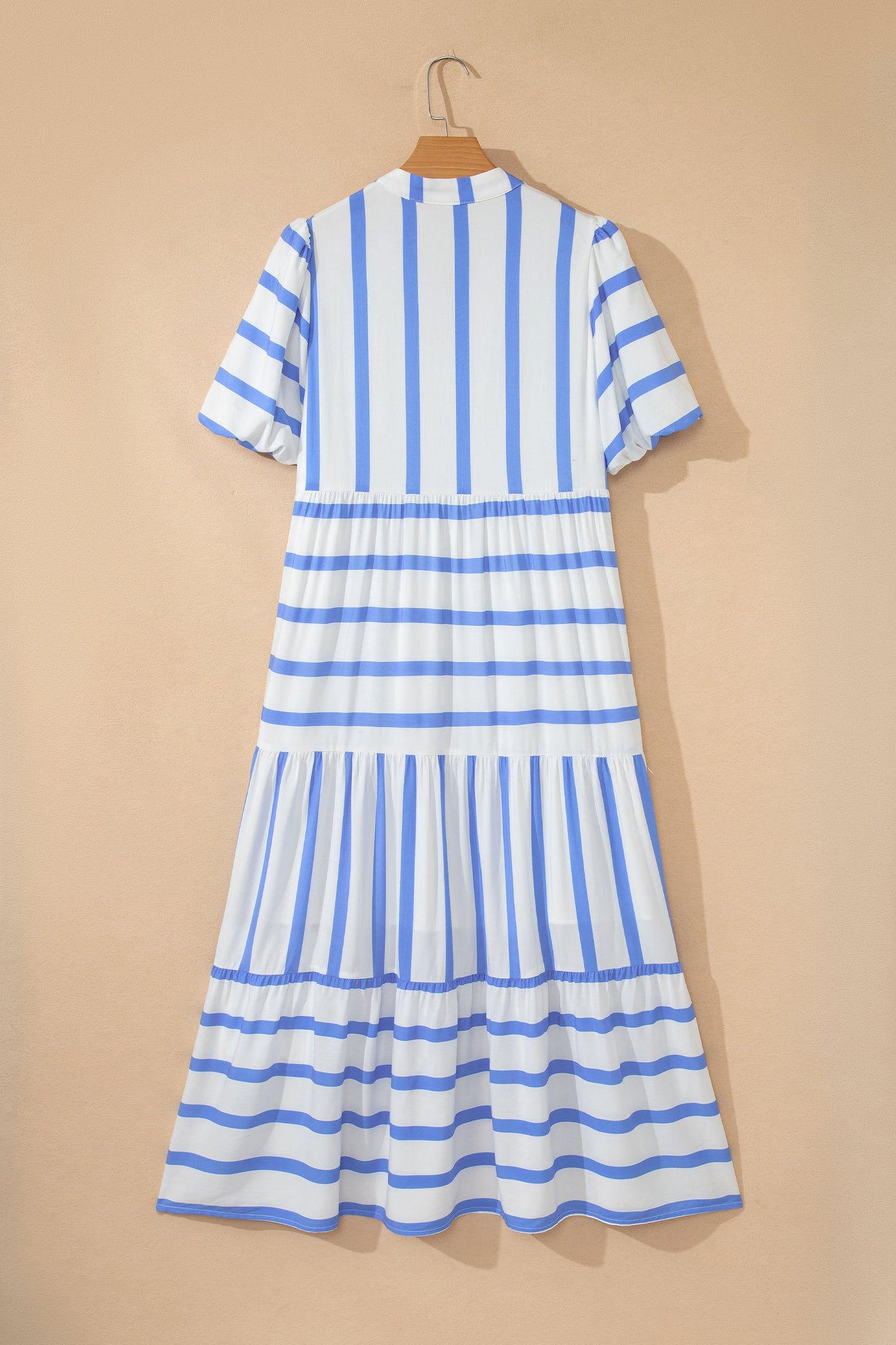 Back view of hanging sky blue striped half-sleeve tiered midi dress