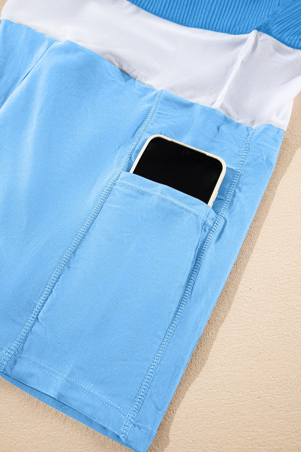 Dusk blue lined swim dress with front pocket opening and stitched seams.