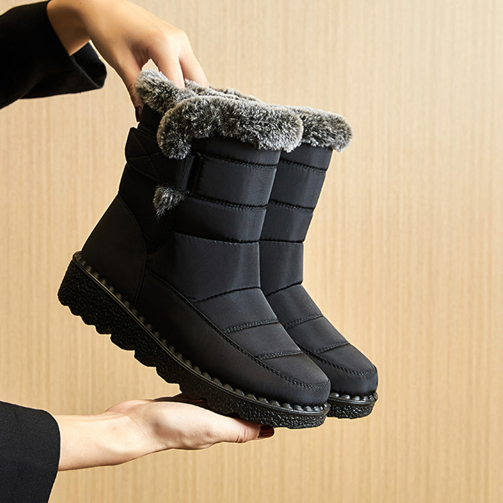 Black snow boots with faux-fur cuff and hook-and-loop strap, rugged platform outsole