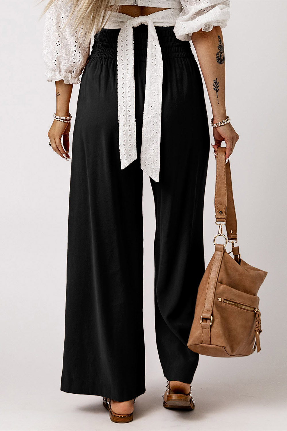 Black wide-leg pants with elastic waistband and long tied drawstring
