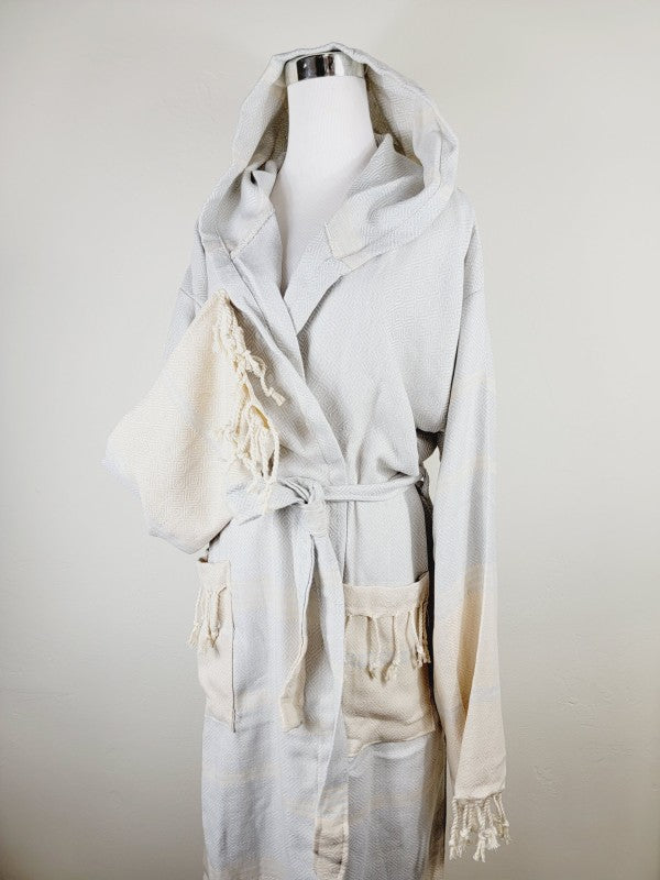 Off-white hooded robe with open front, tie belt, patch pockets, tassel trim