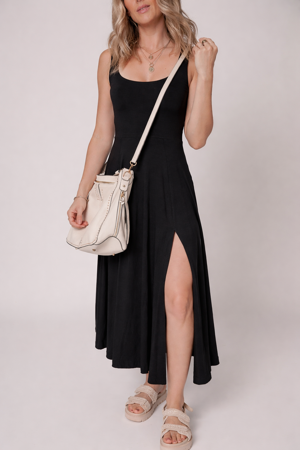 Black sleeveless flared midi dress with scoop neckline and front side slit