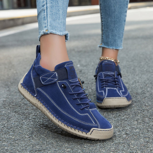 Casual leather boots in navy with lace-up front, side strap detail, and stitched sole.
