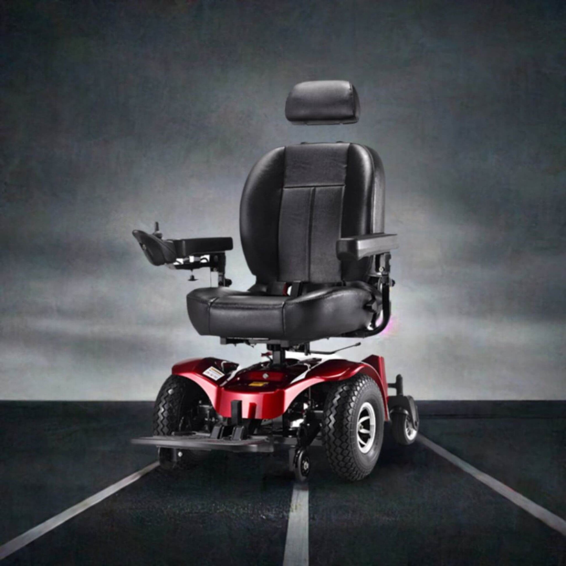 Red power wheelchair viewed from front-left, showing padded black captain’s seat and controls