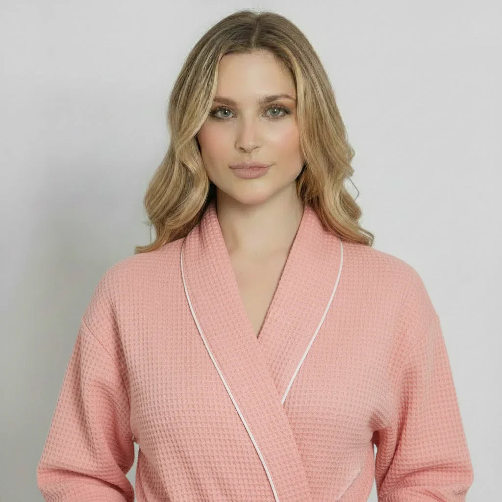 Women’s waffle bathrobe in blush pink with light piping, V-neck wrap collar detail