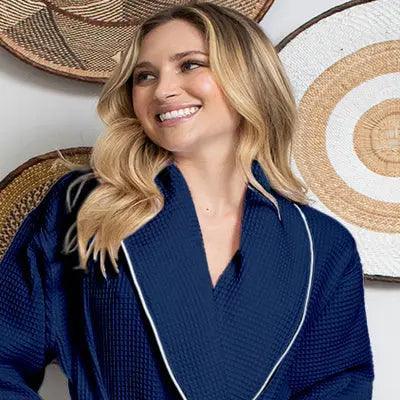 Women’s waffle bathrobe in navy with white piping, V-neck collar, front view.