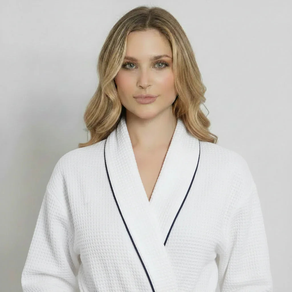 Women’s knee-length waffle robe, white with dark piping, V-neck and belt tie
