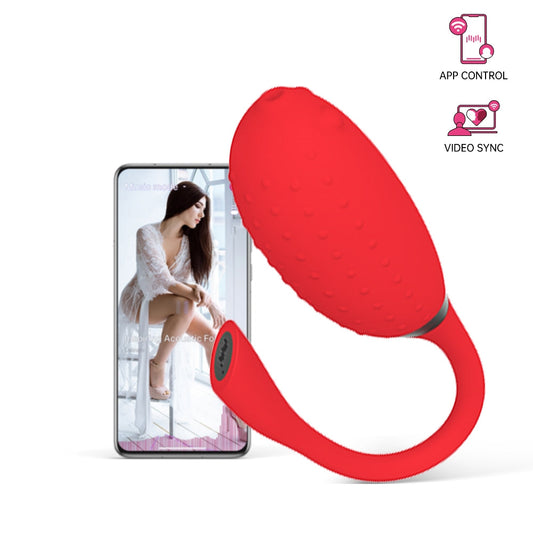 Red silicone handheld massager with textured top and curved loop handle.
