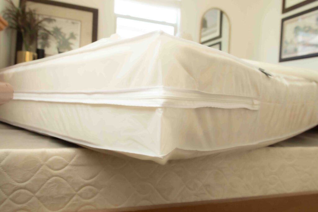 Milky white king plastic mattress protector with waterproof cover over mattress