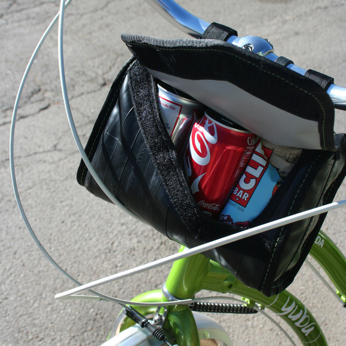 Black cooler handlebar bag with interior cans visible and open top