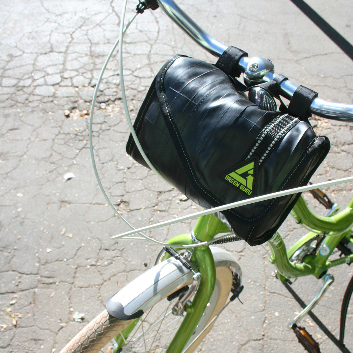 Black cooler handlebar bag with green logo patch and stitched seams