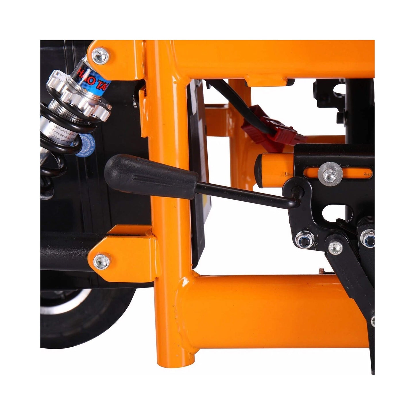 Motivo Heavy-Duty Ultralight Wheelchair: Close-up of orange frame, shock absorber, and black lever mechanism.