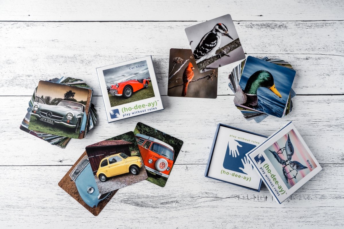 Assorted car show and bird themed activity cards fanned on a tabletop