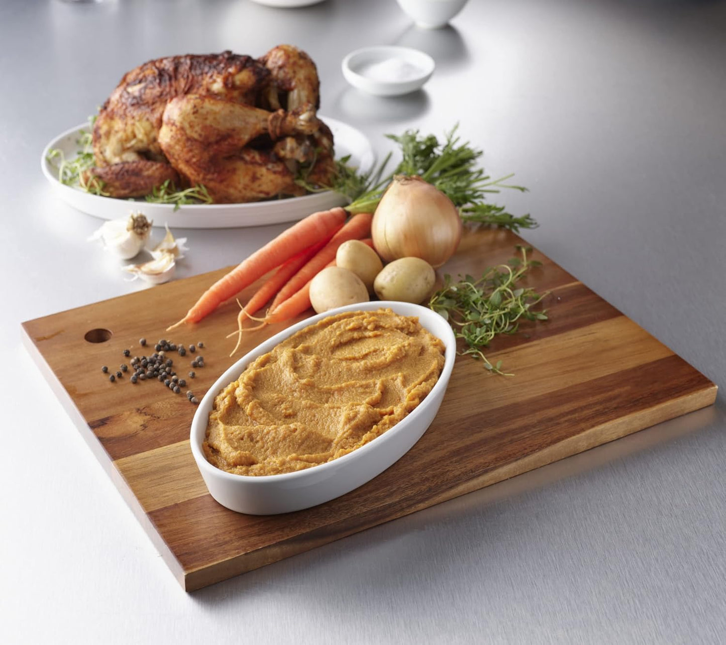 Roasted chicken puree in white serving tray, smooth thick mashed texture