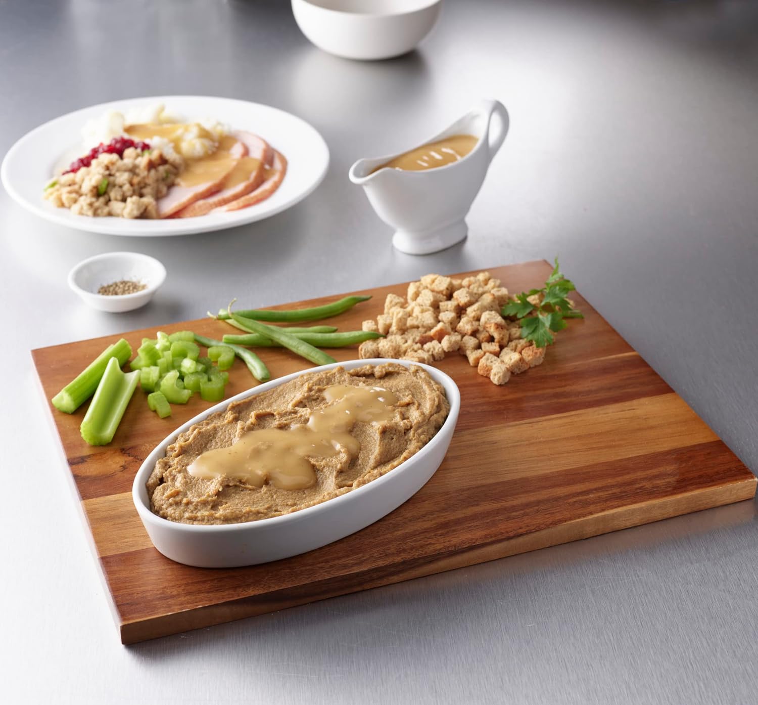 Roasted turkey puree in dish with green beans and other sides on tray