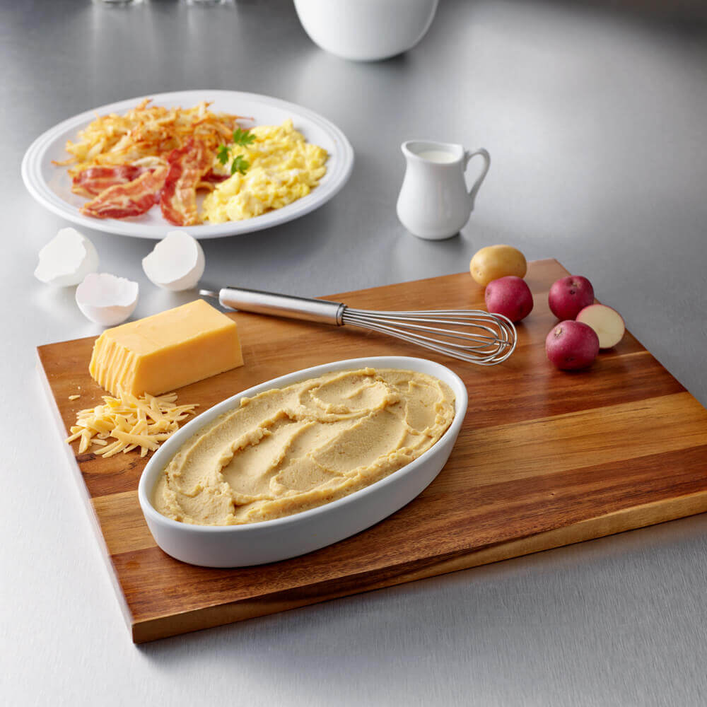 Thick & Easy scrambled eggs puree in a bowl on a cutting board