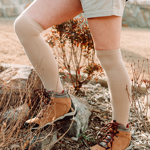 Knee-high bamboo compression socks in beige, worn with brown shoes