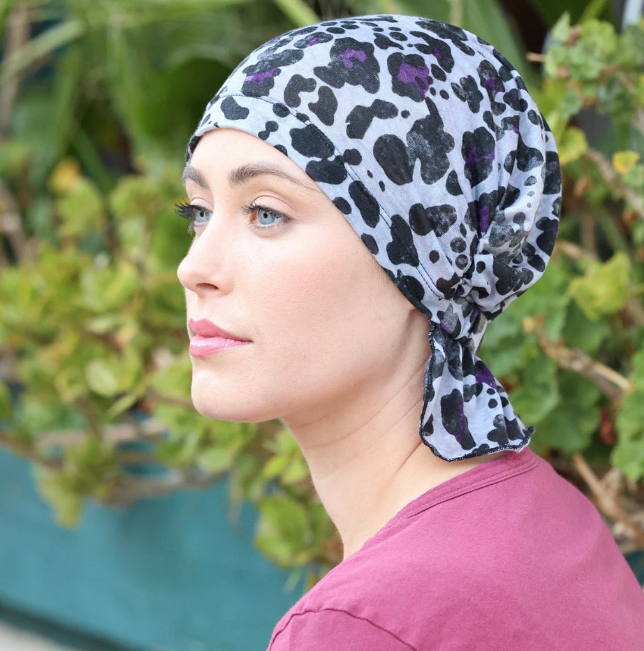 KATY CHEMOBEANIES® chemo beanie, leopard print in black, teal, and purple; side knot