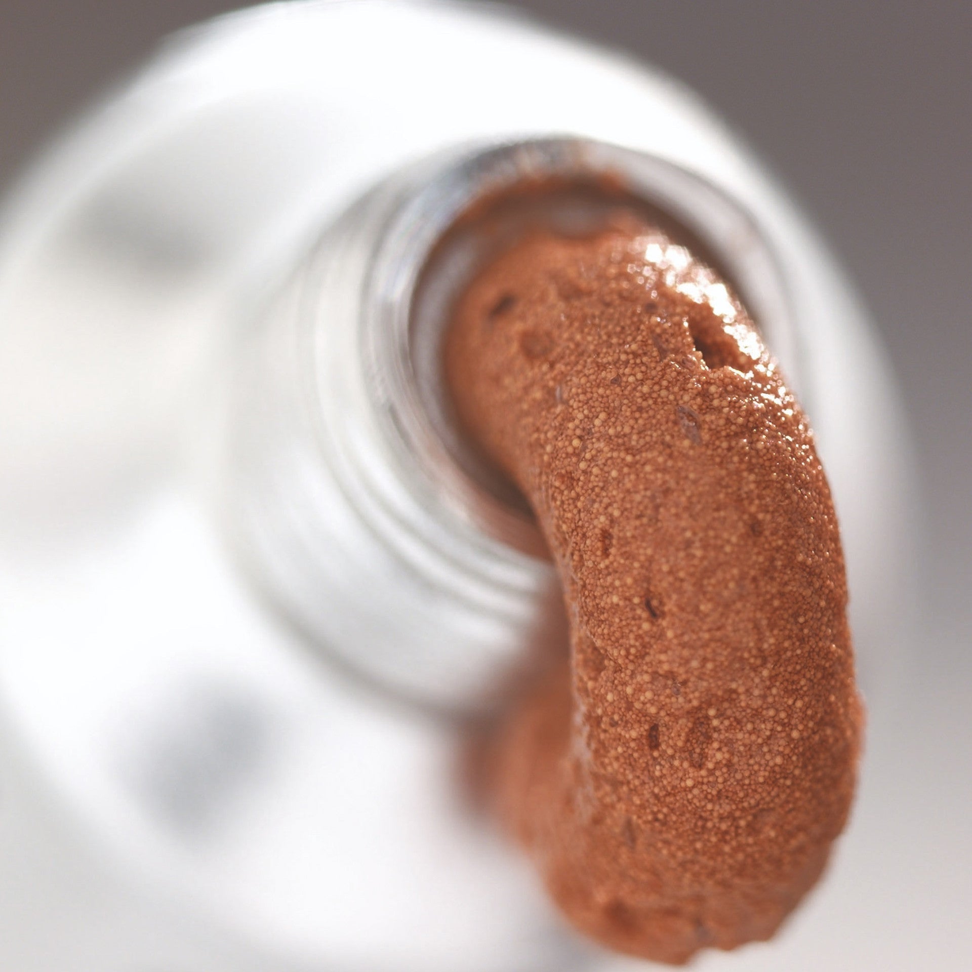 Cadexomer iodine gel texture, brown granular gel sample in a container