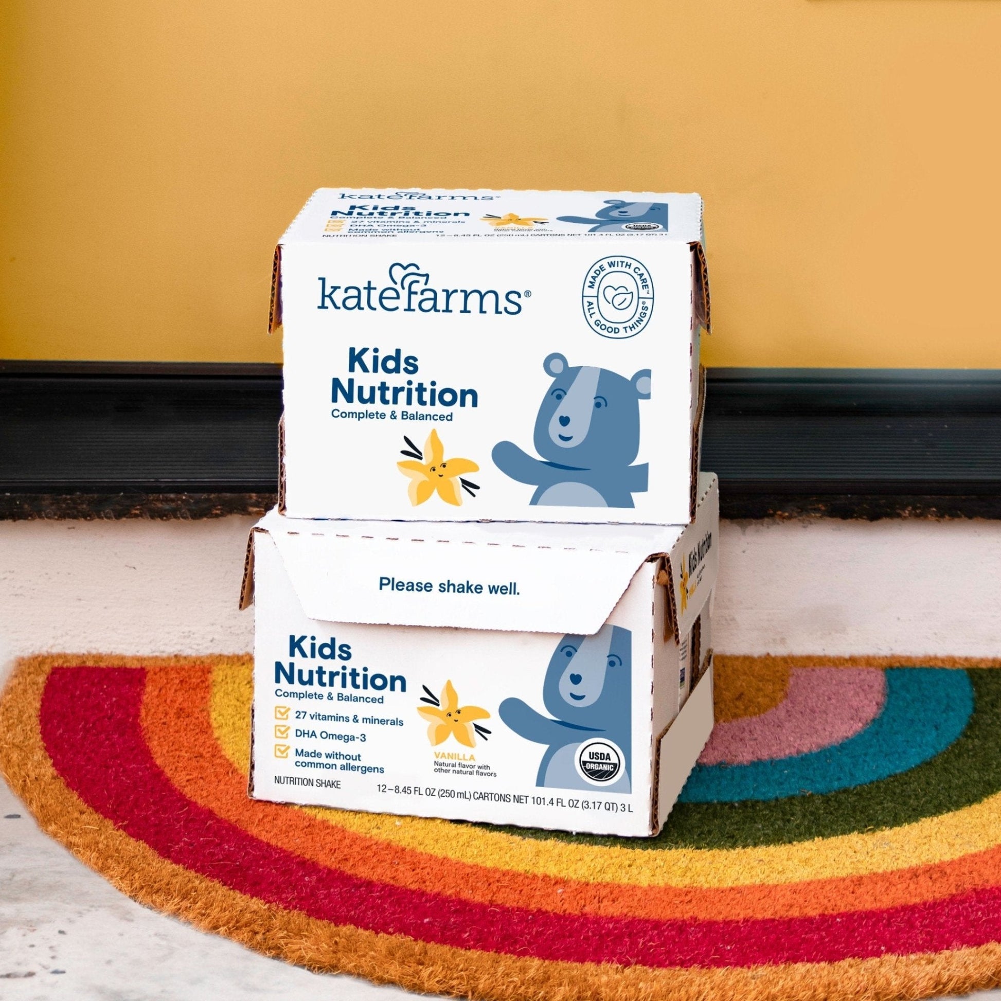 Vanilla Kids Nutrition Shake cartons in an open cardboard shipper box