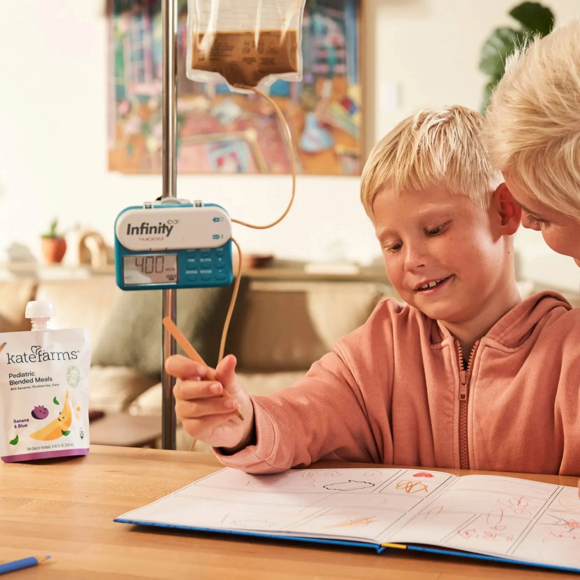 Child and tube-feeding setup with a Kate Farms Banana & Blueberry blended meal pouch