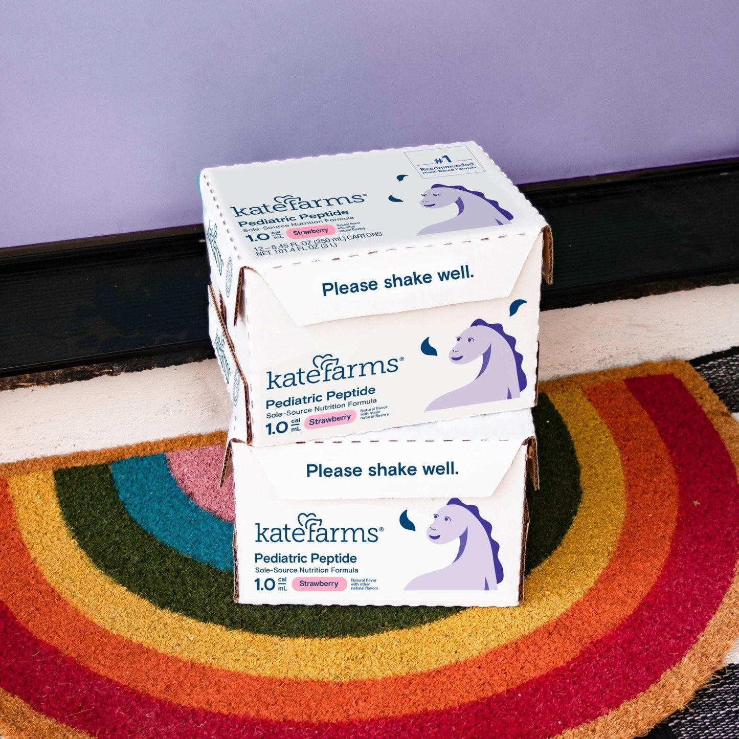 Stacked Pediatric Peptide 1.0 strawberry formula cartons with “Please shake well” text.