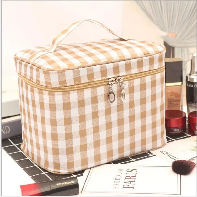 Tan and beige plaid cosmetics toiletry bag with top handle and zip closure