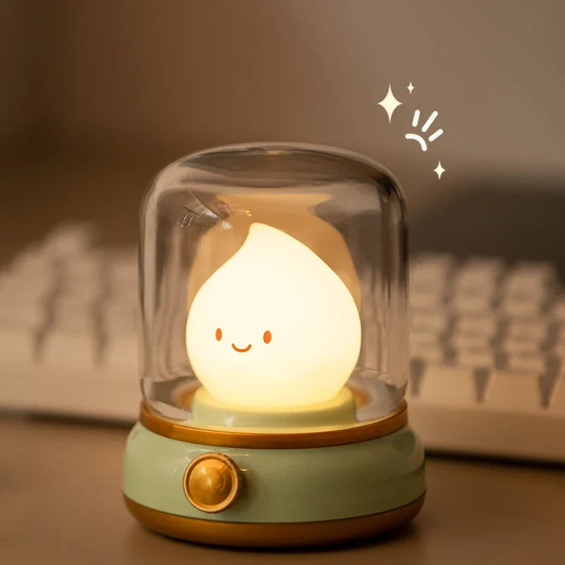 Green flame lantern night light with clear dome and glowing smiling flame face.