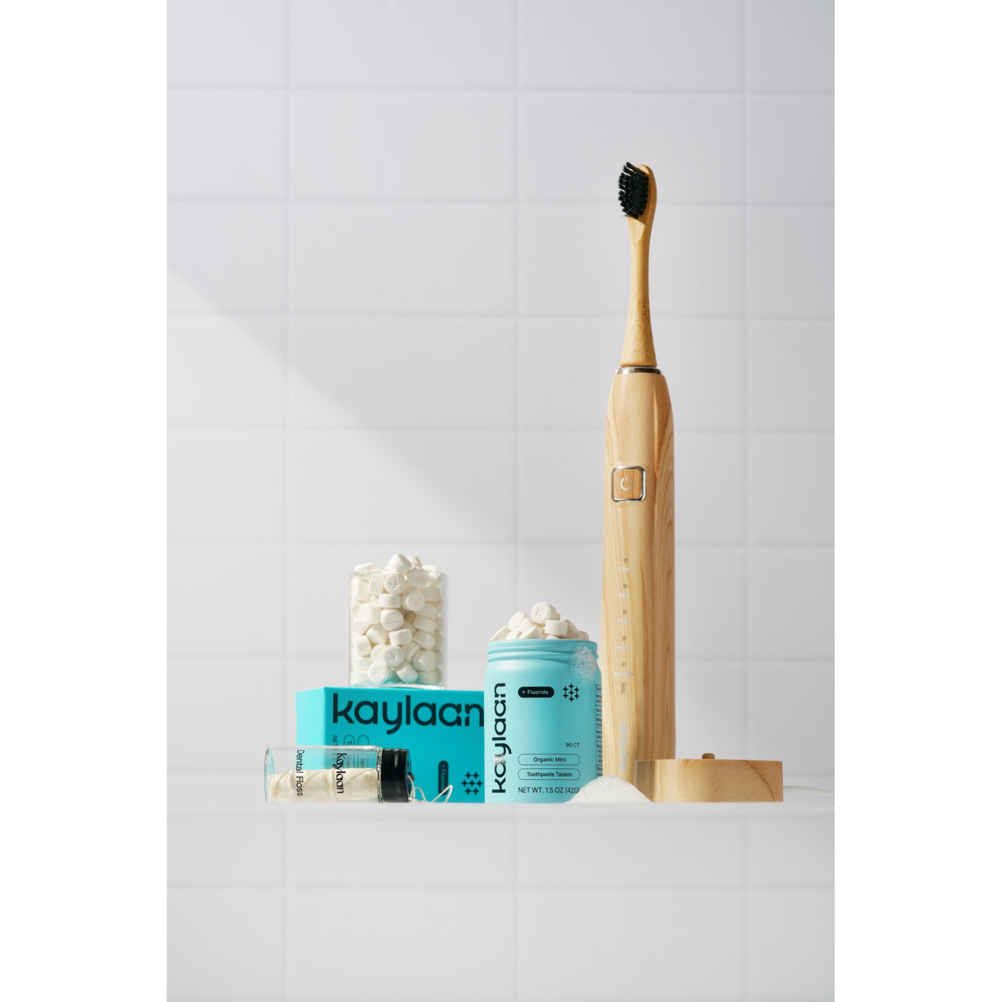 Tooth care starter kit with bamboo sonic toothbrush, mint toothpaste container, and tablets