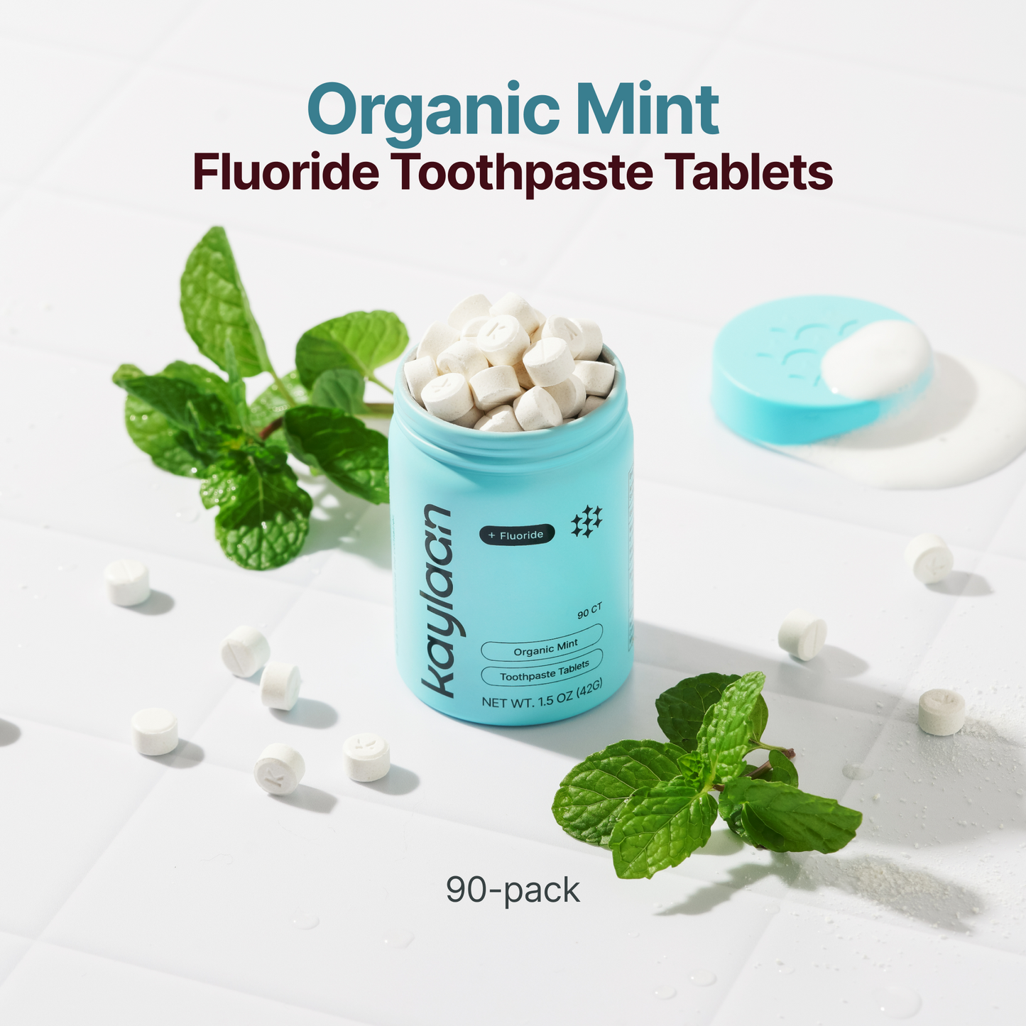 Organic mint fluoride toothpaste tablets in blue canister with mint leaves