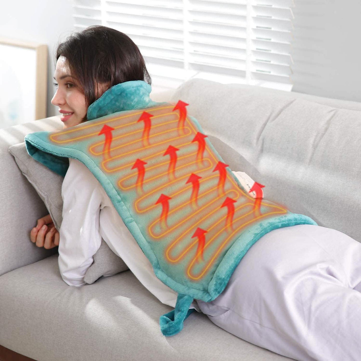 Turquoise back heating pad blanket laid across lap and torso, with heating cable pattern