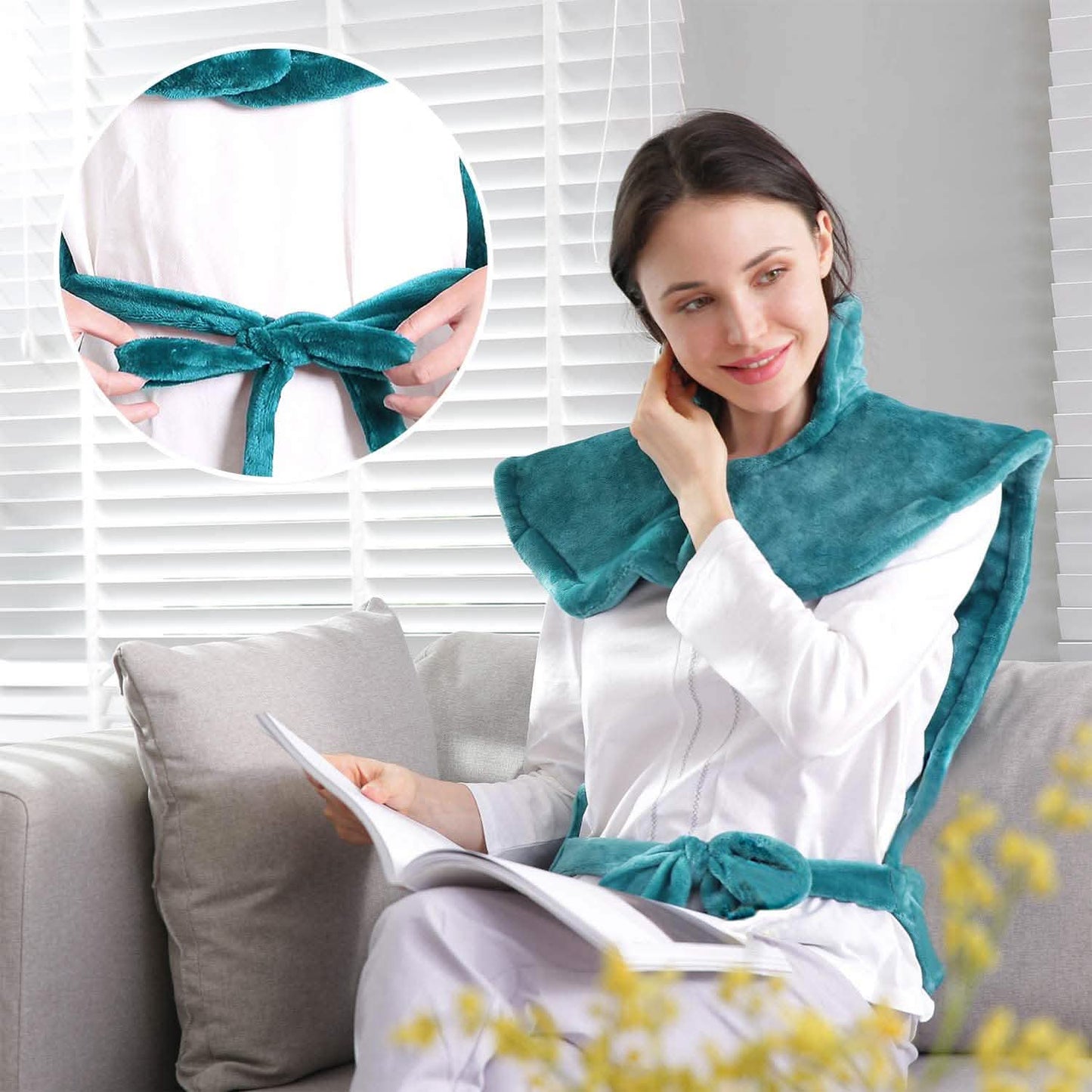 Turquoise heating pad scarf-style for shoulders and neck, tied in a bow