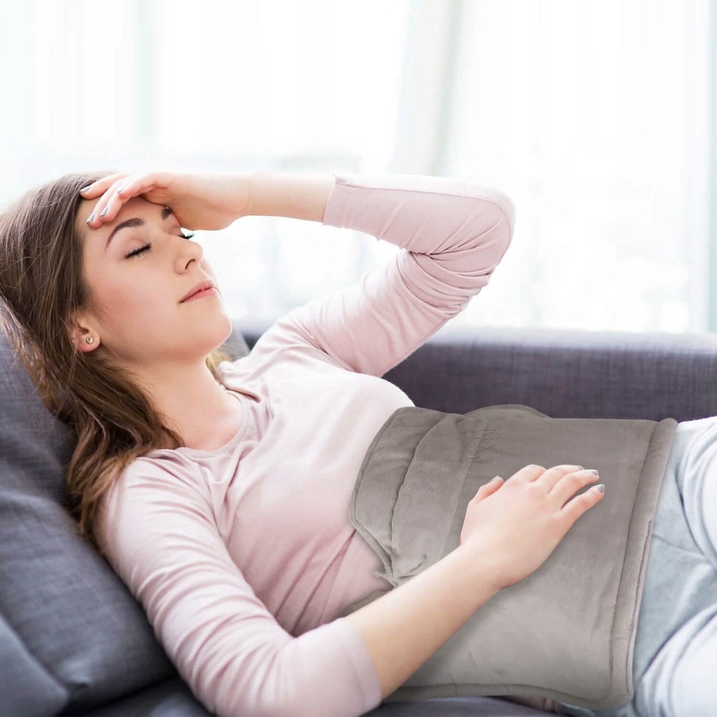 Neck and shoulder heating pad in grey, weighted cushion resting on shoulders