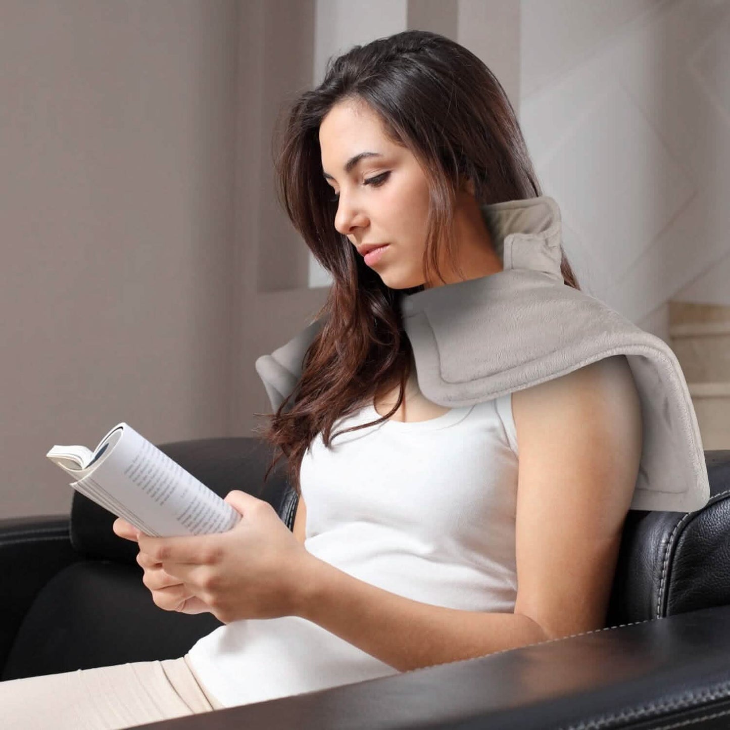 Grey U-shaped heating pad for neck and shoulders, secured around shoulders