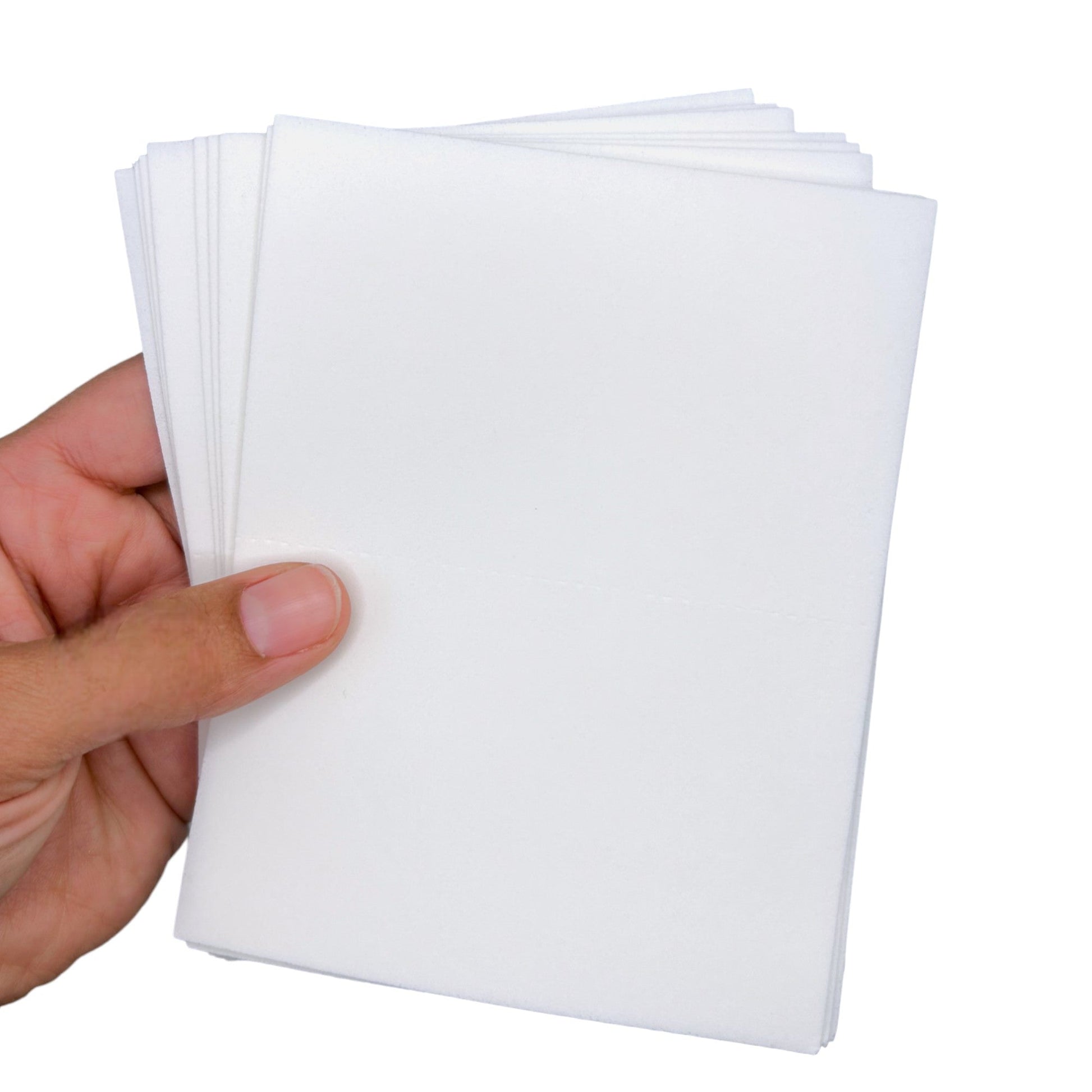 Laundry detergent sheets in hand, dissolvable white sheets, plant-based