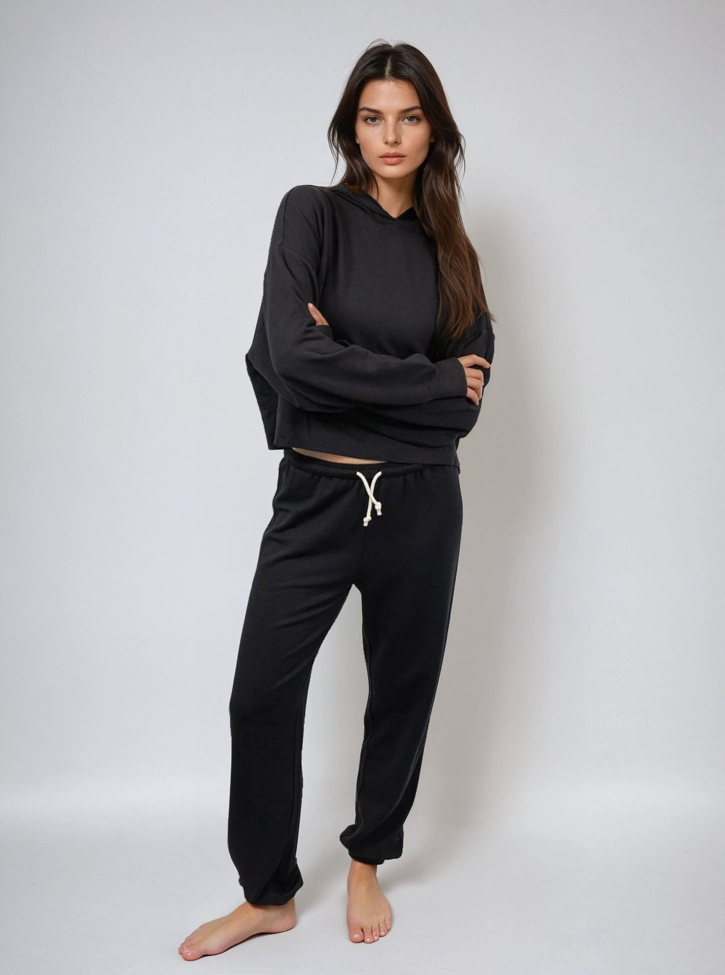Black cropped hoodie, front view with hood and drawstring; relaxed long sleeves