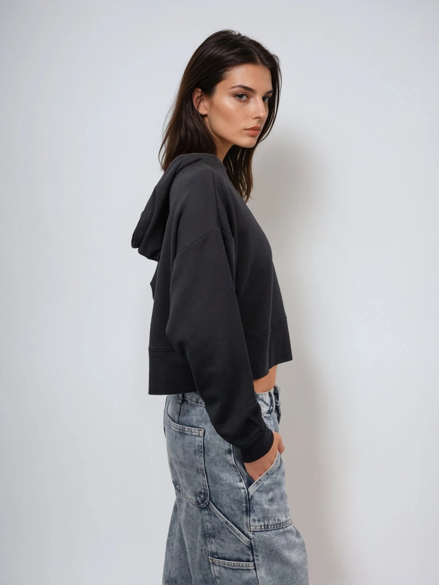 Black cropped pullover hoodie side profile with hood and long sleeves