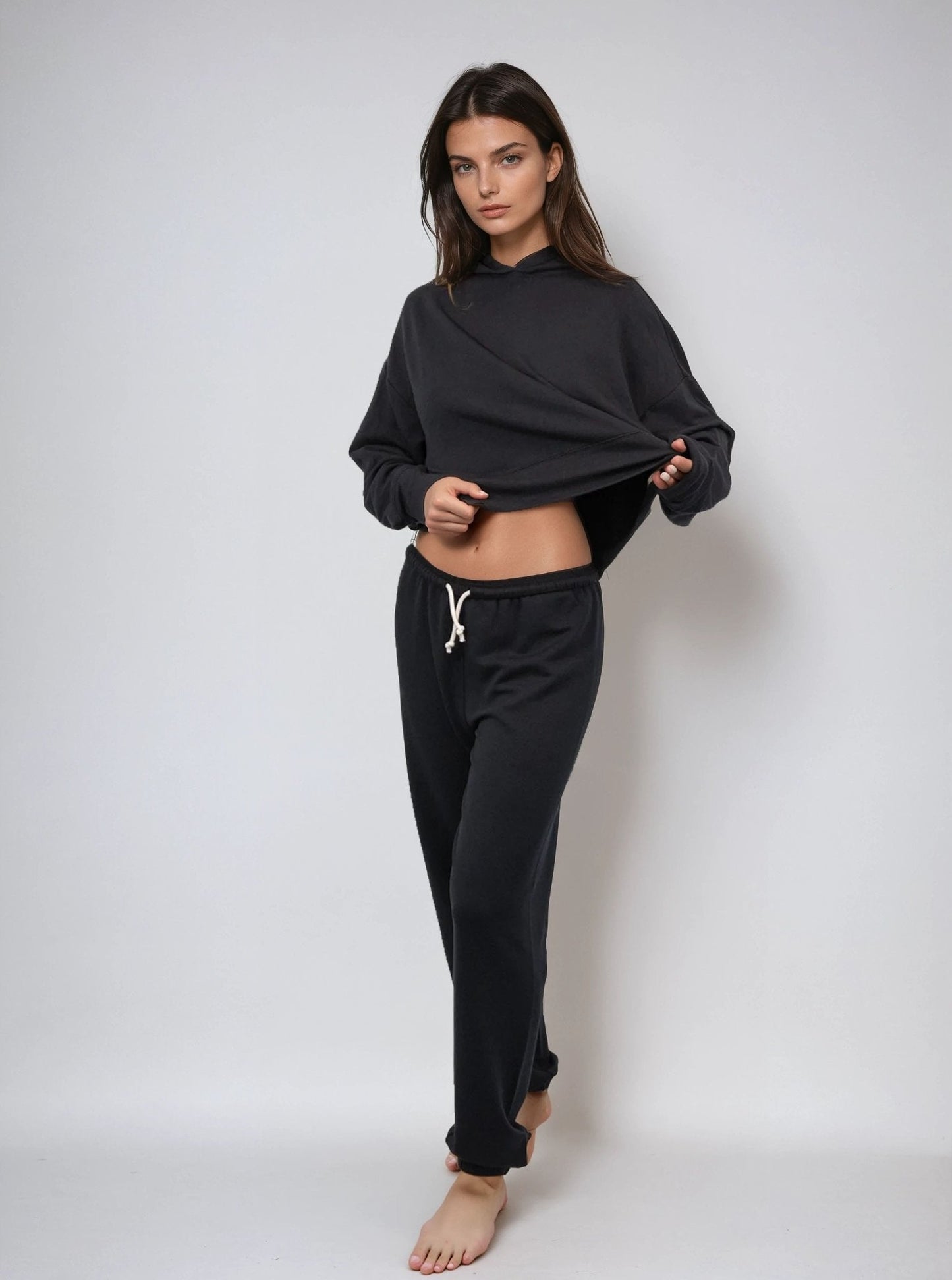 Black cropped pullover hoodie with hood and kangaroo pocket, cropped hem