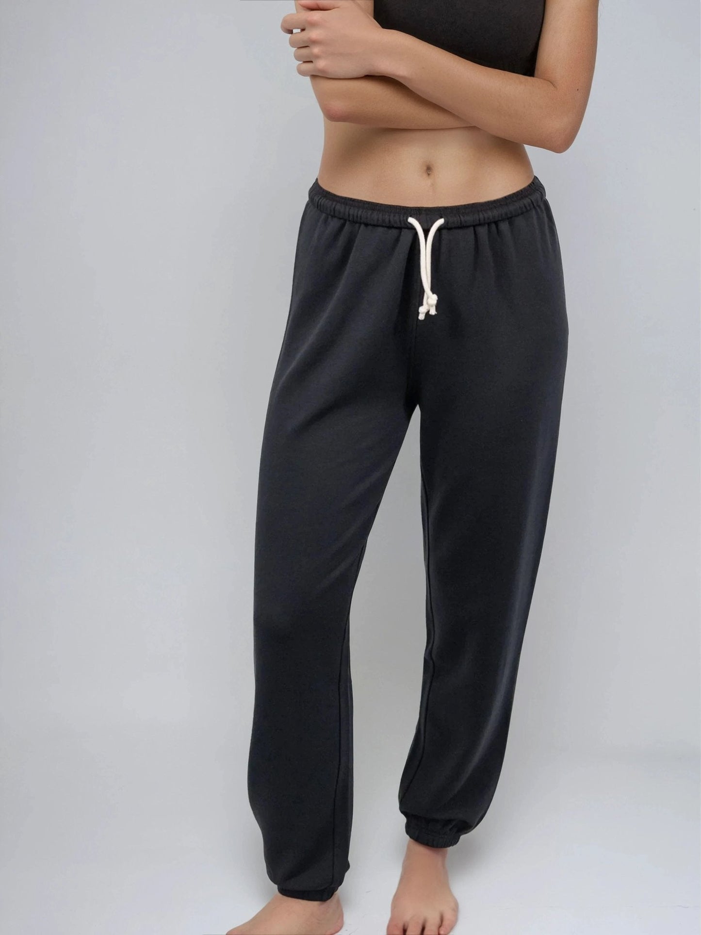 Black lounge sweatpants with cuffed ankles and drawstring waist