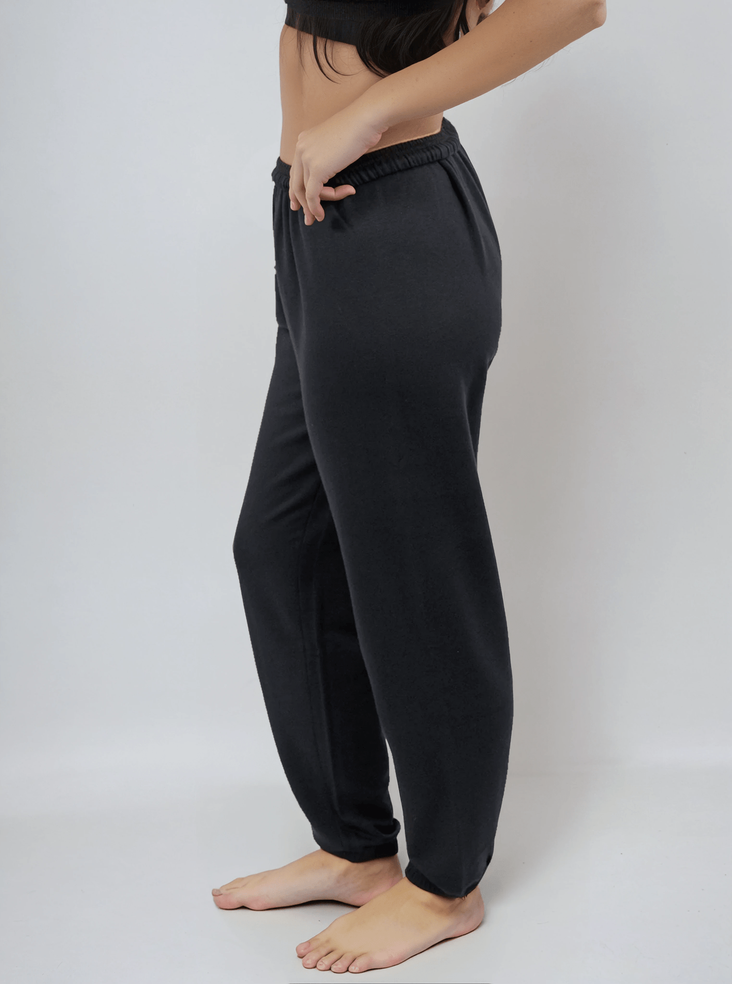 Black lounge sweatpants with relaxed leg and elastic ankle cuffs