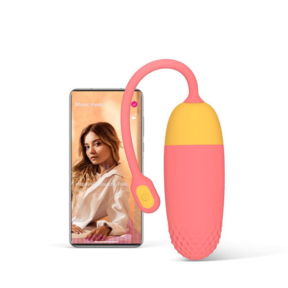 Pink and yellow loop-handled silicone massager with textured bottom