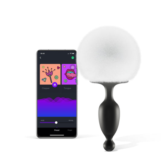 App-controlled bunny tail massager with black silicone body and white fuzzy pom