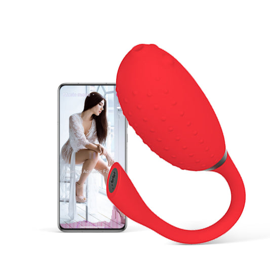 Red silicone teardrop massager with curved handle and textured grip surface.