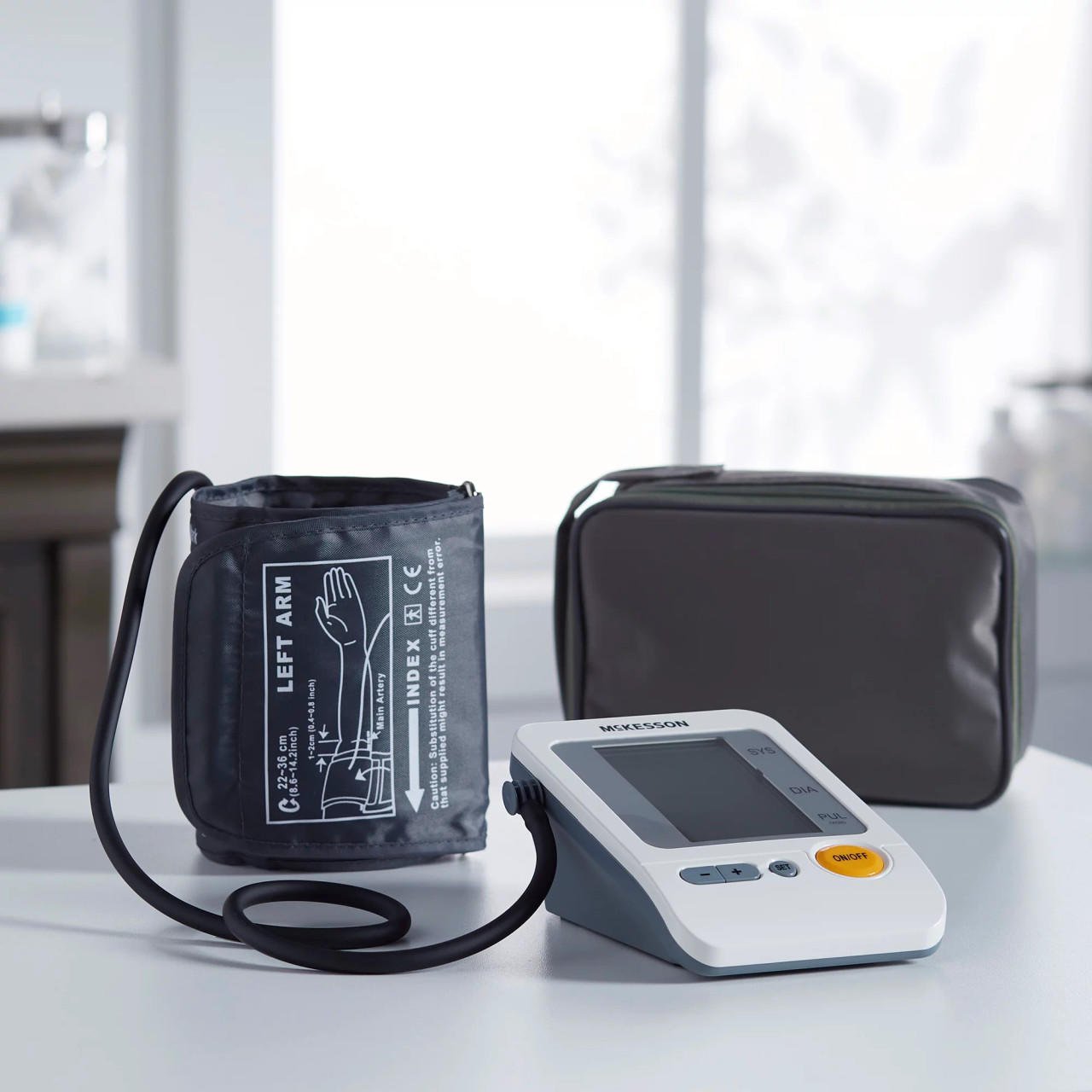 Digital blood pressure monitor with left arm cuff, display unit, and zip carrying case