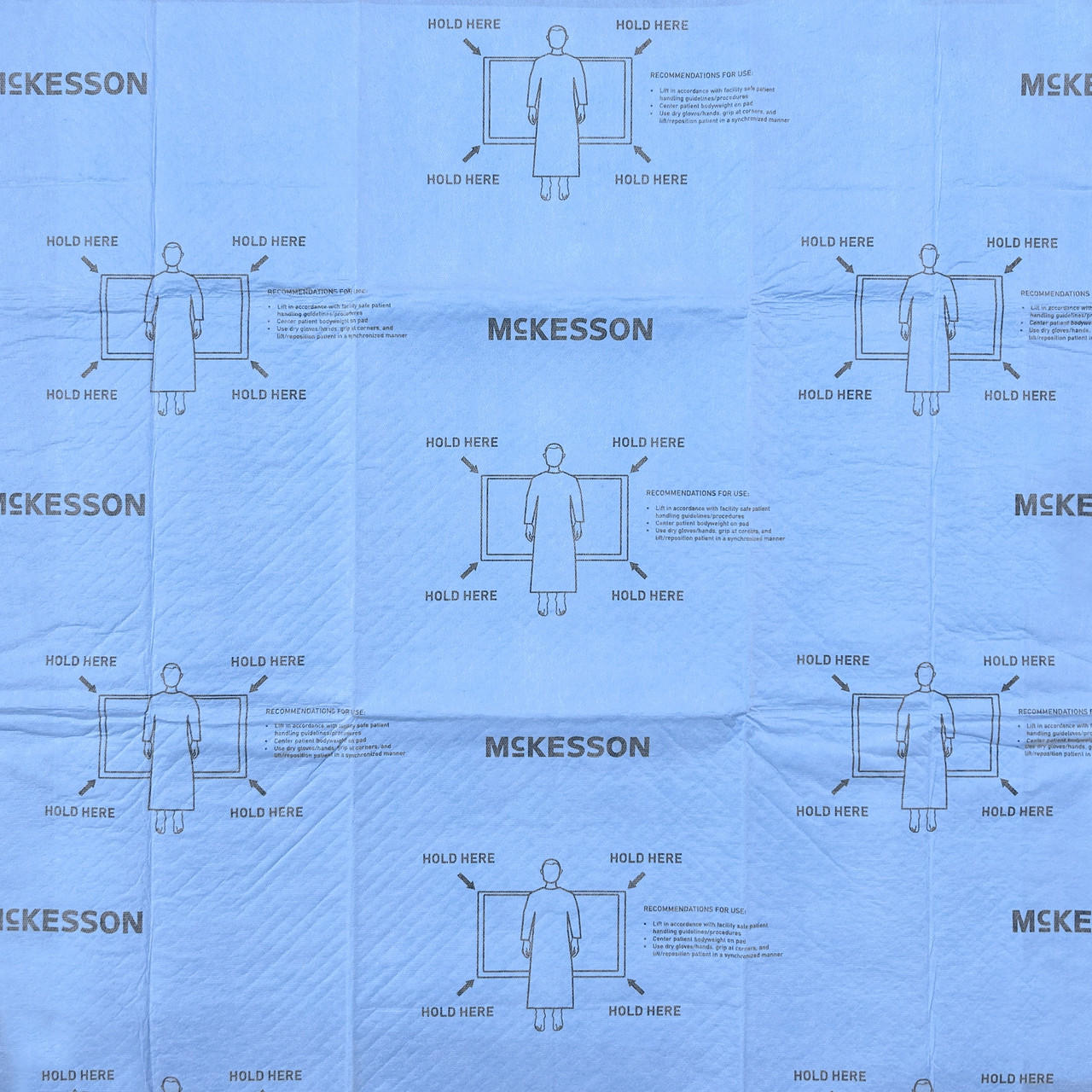 Blue heavy-duty repositioning underpad packaging with repeated hold-here icons