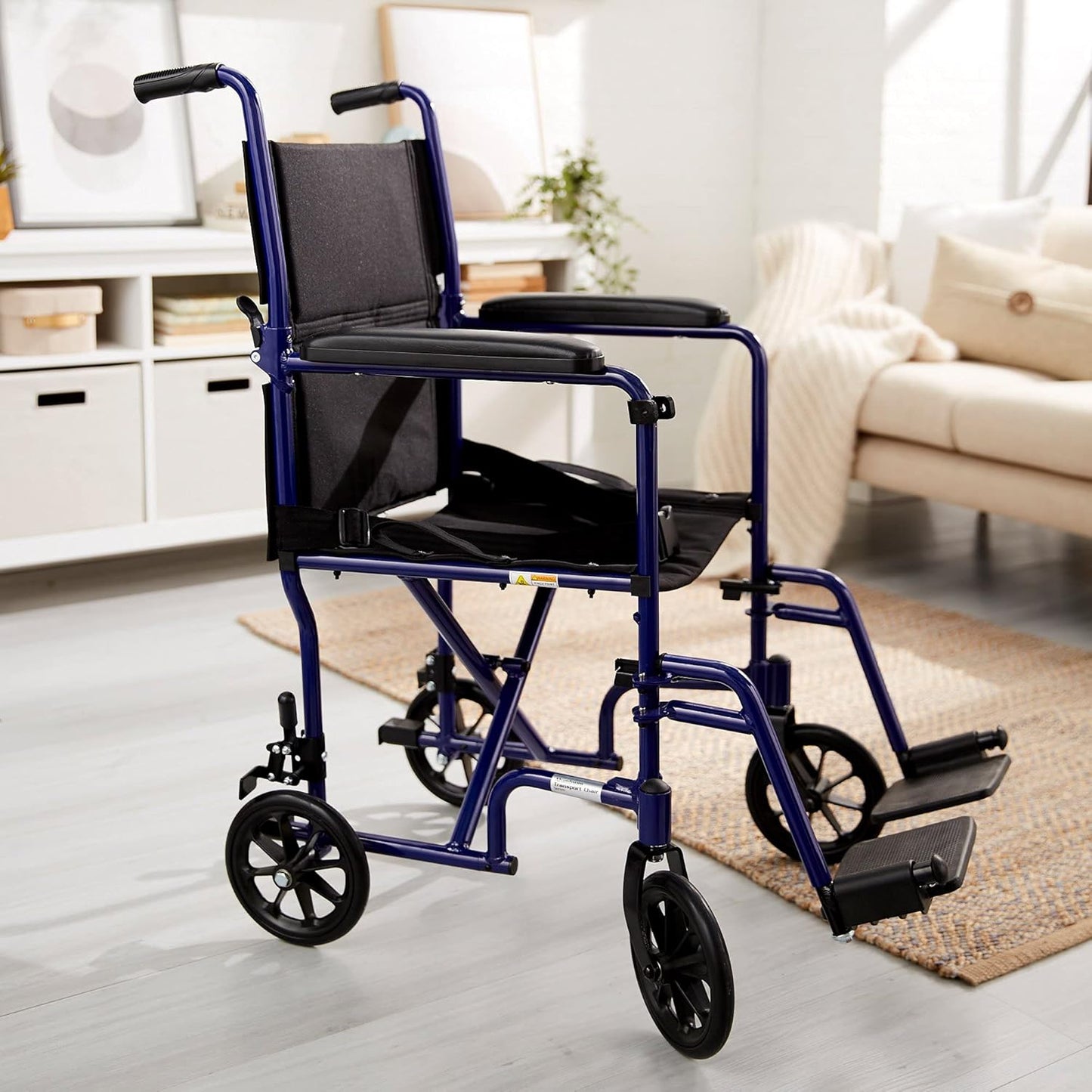 Transport chair side view with blue frame, large wheels, padded arms, and black seat