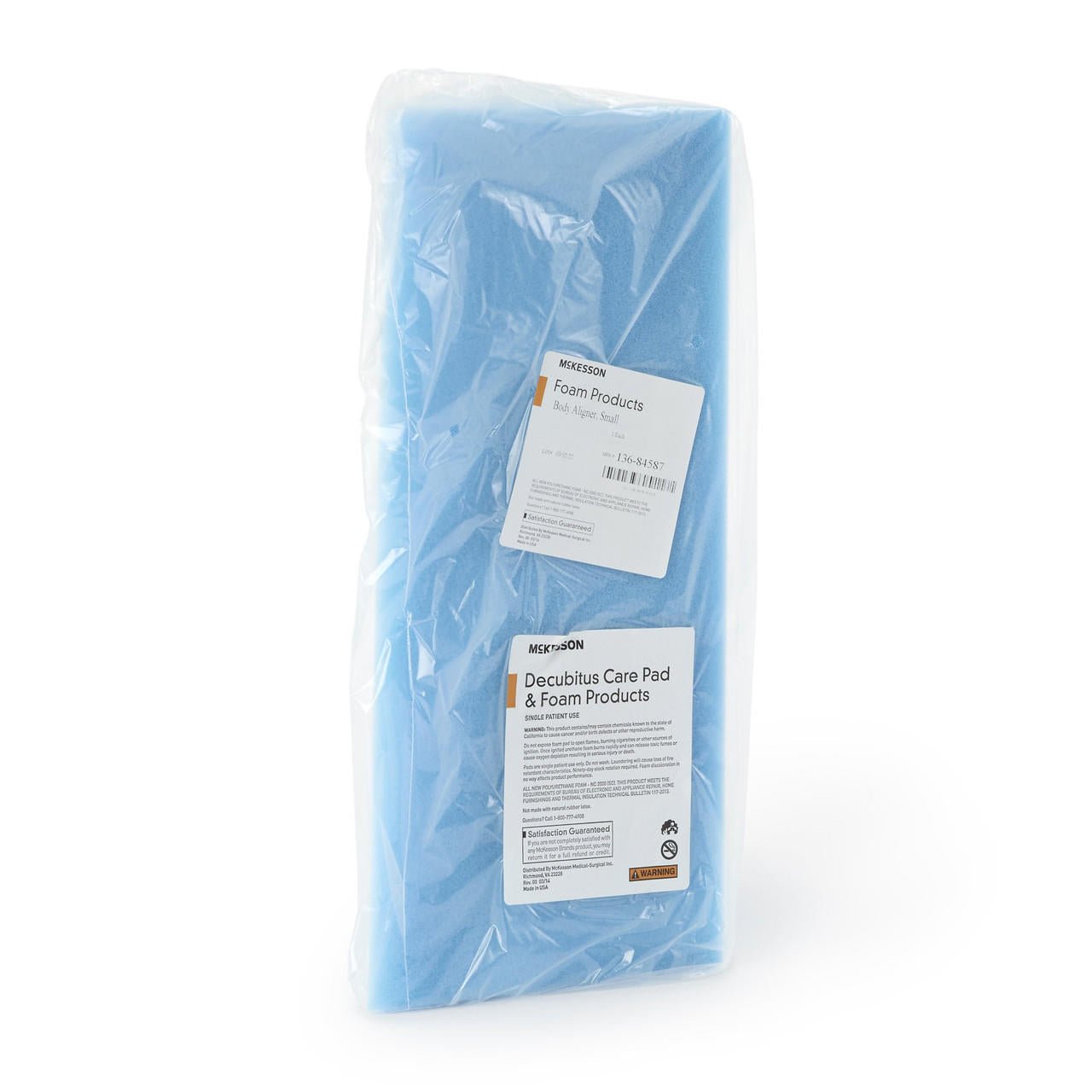 Blue foam positioning wedge pad in clear plastic wrap.