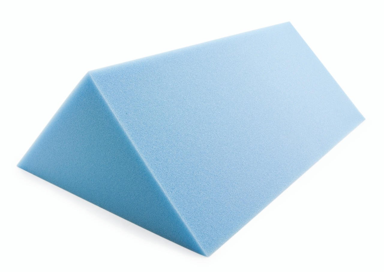 Blue foam positioning wedge pad with slanted top and angled sides.