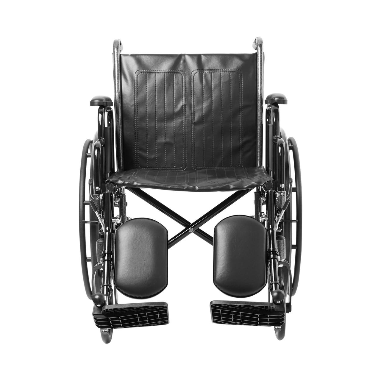Black wheelchair front view with padded backrest, desk arms, and footplates